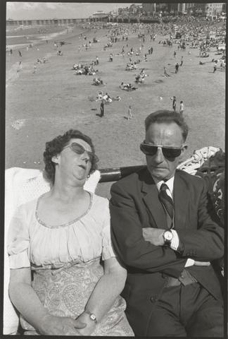 Man and Woman Sitting in Sun with Sunglasses