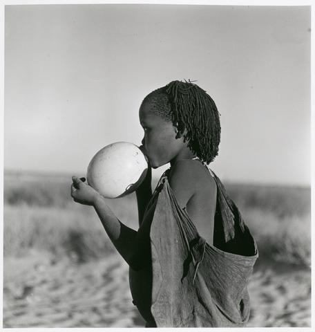 Constance Stuart Larrabee Bushman Girl Using Ostrich Egg as Water Bottle, Kalahari Desert, 1947