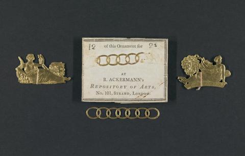 Packet of embossed gilt paper ornaments.