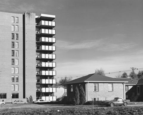 Robert Adams, Untitled (apartment tower and house), 1970–74