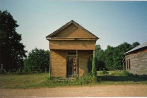 William Christenberry, Building with false brick siding, Warsaw, Alabama, 1974, printed 2007