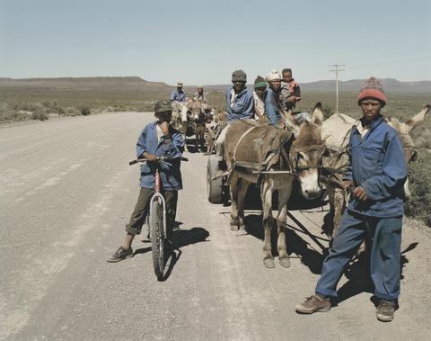 David Goldblatt, Swerwers, nomadic sheep shearers, and farmworkers, descended from the San hunter gatherers and Khoi pastoralists. Without work for four months they lived in the "gang," the corridor between farms fences and roads, hunting, fishing when they could and eating roadkill. Near Nuwe Rooiberg, Northern Cape, 18 September 2002, 2002, printed later