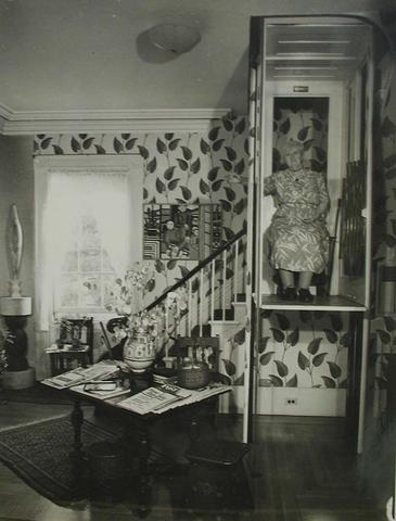 John Schiff, Interior view of Katherine S. Dreier's Milford home, "Laurel Manor" -- KSD in elevator, sitting, frontal, 1948