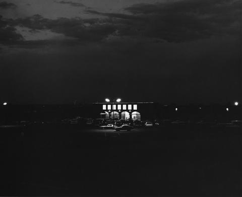 Robert Adams, Untitled (lit shopping center and parking lot at night), 1970–74